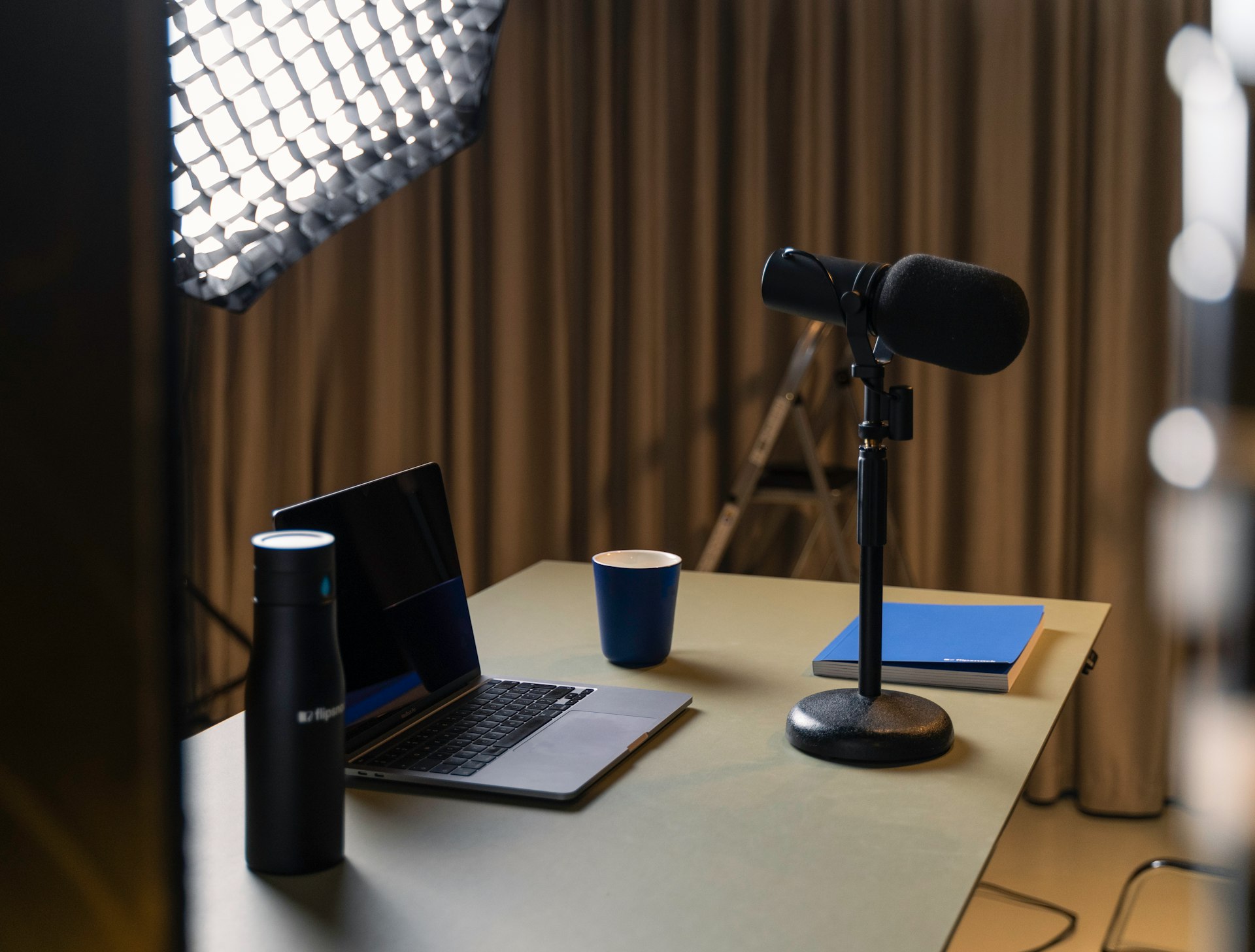 a laptop and a coffee cup on a desk